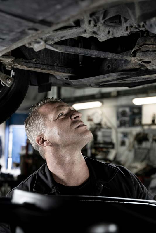 mechanic checks car for MOT test